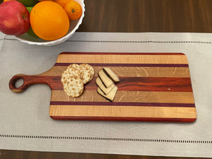 Rectangle cutting board with small circle handle.